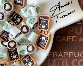 May include: A white ceramic dish filled with miniature coffee cups and signs that say "Delicious coffee". The dish is on a brown background with the words "Annie's Treasures", "Cafe", "Espresso", "Frappuccino", "Latte", "Mocha", and "Coffee" printed on it.