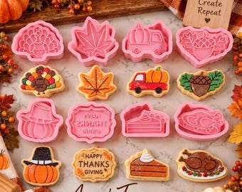 May include: A collection of pink plastic cookie cutters and matching decorated sugar cookies arranged in a grid. Shapes include a turkey, maple leaf, truck with pumpkin, acorn, pumpkin with hat, pie slice, and a plaque with the text Happy Thanksgiving.