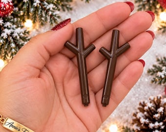 May include: Two dark brown plastic stick-shaped components, each featuring a Y-shaped top branch and a small circular indentation near the base. These smooth, rigid pieces are designed with a straight vertical stem and a short angled side branch.