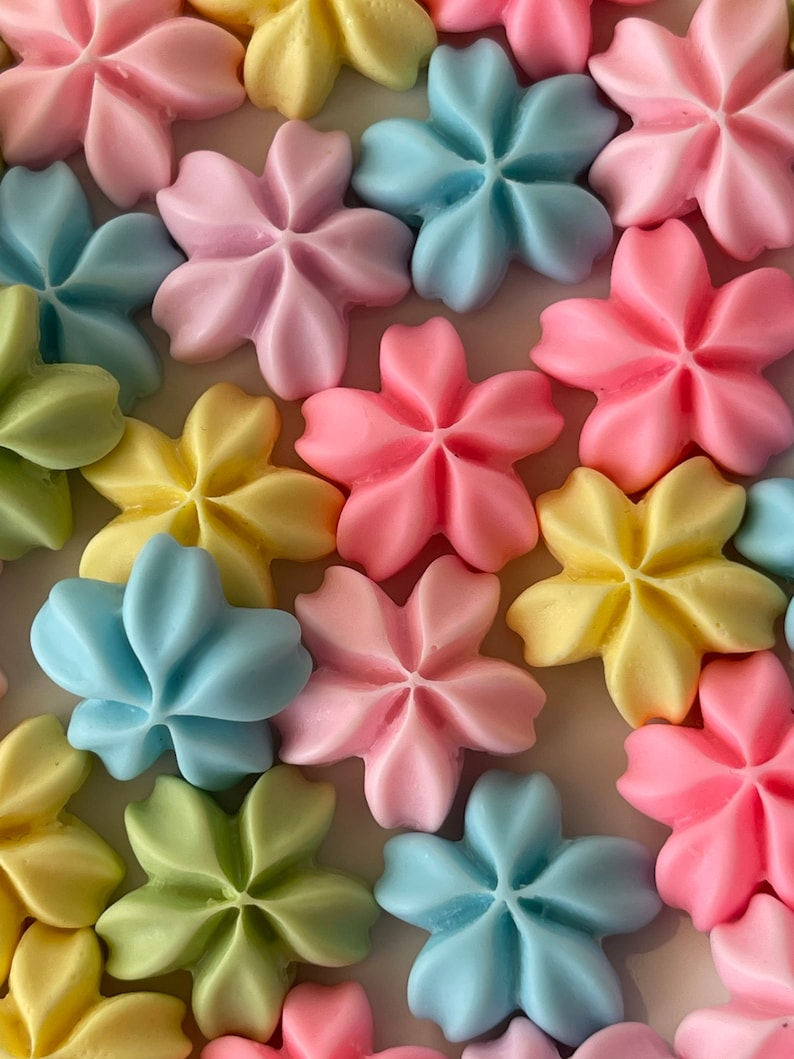 May include: Assortment of pastel-colored sugar cookies shaped like five-pointed stars. The cookies are in shades of pink, blue, yellow, and green.