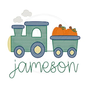 May include: An embroidery design featuring a green train engine with blue wheels and a yellow front light, pulling a cargo car filled with two orange pumpkins. Two light gray clouds float above the engine. The name Jameson is stitched below.