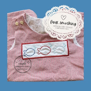 May include: Red and white striped seersucker romper with a white collar and three wooden buttons. The front features a rectangular patch with embroidered fish in blue, red, and light blue. The text "faux smocking" is displayed on a white doily.