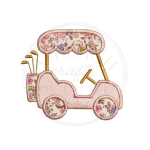 May include: A pink golf cart illustration with floral patterned accents. The cart features a canopy, steering wheel, and a golf club bag. The golf club bag and canopy are decorated with a floral pattern. The cart has gold-colored support beams and a steering wheel.