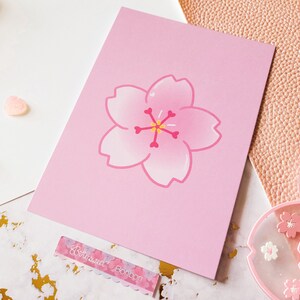 May include: A pink card with a pink cherry blossom illustration. The card has a white border and the text "Betwixtweed Bonbon" is printed on the bottom.
