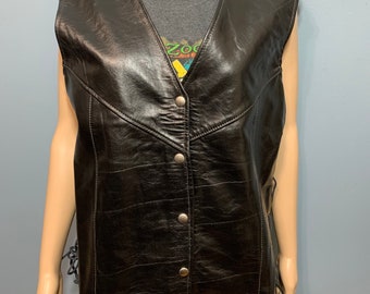 May include: A black leather vest with a snap closure and lace-up sides.