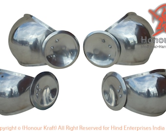 May include: Four silver metal shoulder armor pieces with round, raised, decorative plates. The armor is polished and reflective.