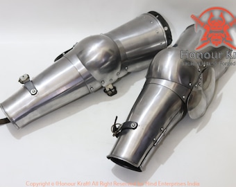 May include: A pair of silver metal elbow guards with straps and buckles. The guards are made of metal and have a smooth, polished finish. The guards are designed to protect the elbows from injury.