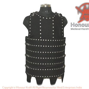 May include: A black leather armor vest with silver rivets. The vest has a pointed bottom and is worn on a mannequin. The text "Honour Kraft" and "Medieval+Hand+Forged+Armor" is visible in the image.