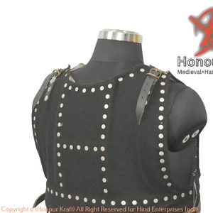 May include: Black leather armor with silver rivets and straps. The armor is displayed on a mannequin. The text "Honour Kraft Medieval+Hand+Forged+Armor" is visible in the upper right corner of the image. The text "Copyright Honour Kraft) All Right Reserved for Hind Enterprises India" is visible at the bottom of the image.