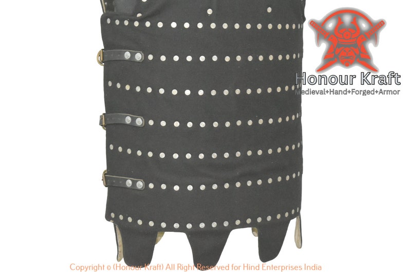 May include: A black leather cuirass with silver rivets and leather straps. The cuirass has a pointed bottom and is decorated with a row of silver rivets around the bottom edge.