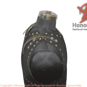 May include: Black leather armor with white dots and metal buckles. The armor is on a mannequin and is designed to protect the chest and shoulders. The text "Honour Kraft" and "Medieval+Hand+Forged+Armor" is visible in the image.