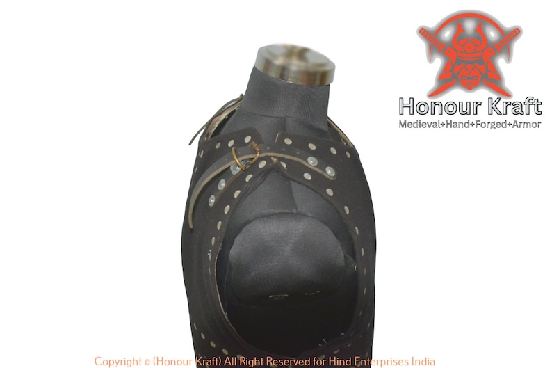 May include: Black leather armor with white dots and metal buckles. The armor is on a mannequin and is designed to protect the chest and shoulders. The text "Honour Kraft" and "Medieval+Hand+Forged+Armor" is visible in the image.