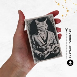 May include: A monochrome rectangular card featuring a cat in a suit, holding a book. The text "I Read Books and I Know Things" is displayed. The card also has the words "Instant Download".