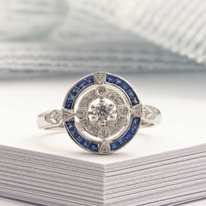 Antique Art Deco inspired white gold ring with diamond and blue sapphier halo