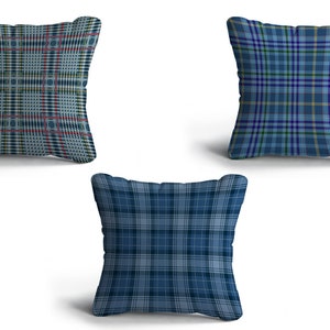 May include: Three blue and white plaid throw pillows. The pillows are square and have a soft, plush texture.