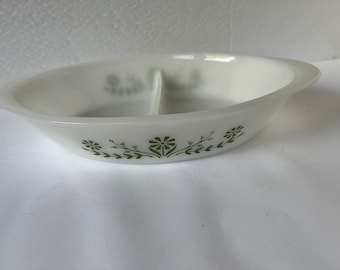 May include: White divided serving dish with a green floral design. The dish has a divided center with two sections.