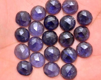 May include: A collection of 25 faceted, round, dark blue gemstones. The gemstones are approximately 10mm in diameter and have a polished, faceted finish.