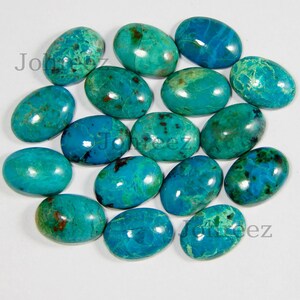 May include: A collection of 16 oval-shaped turquoise cabochons. The stones are a vibrant blue-green color with brown and white marbling.