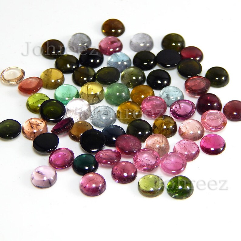 May include: Assortment of round, cabochon cut gemstones in various colors, including pink, green, brown, and black. The gemstones are approximately 6mm in diameter and are ideal for jewelry making.