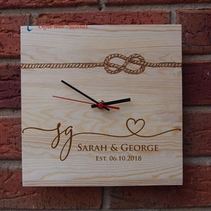 May include: A wooden clock with a rope knot design and the text "sg SARAH & GEORGE EST. 06.10.2018" engraved on the face.