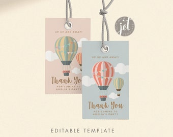 Può includere: Due etichette di ringraziamento stampabili con un tema di mongolfiera. Le etichette sono blu chiaro e rosa con uno sfondo bianco. Il testo sulle etichette dice "Up Up and Away!" e "Grazie per essere venuto alla festa di Amelia".