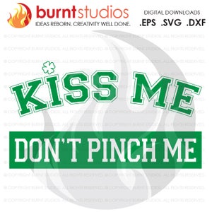 May include: Green and white graphic with the text "Kiss Me" and "Don't Pinch Me" in a bold, blocky font. The graphic features a shamrock.