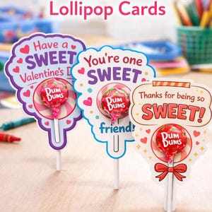 May include: Printable Valentine's Day lollipop cards with the text "Have a SWEET Valentine's Day", "You're one SWEET friend!", and "Thanks for being so SWEET!" Each card holds a Dum Dums lollipop.