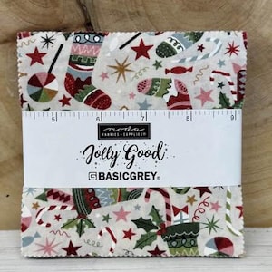 May include: A bundle of festive fabric squares featuring Christmas motifs like stockings, stars, and candy canes. The fabric has a cream background with red, green, and blue details. The label reads "Jolly Good" by BASICGREY.
