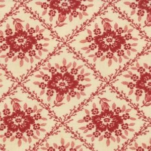 May include: A repeating pattern of red floral designs on a cream background. The floral design features a central flower with smaller flowers and leaves surrounding it. The pattern is arranged in a diamond shape.