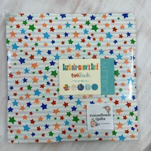 May include: A fabric bundle with a star design in red, orange, green, and blue on a white and light blue striped fabric. Includes labels with text: "Bartholo-meow's Reef" and "Cottonflower Quilts handmade".
