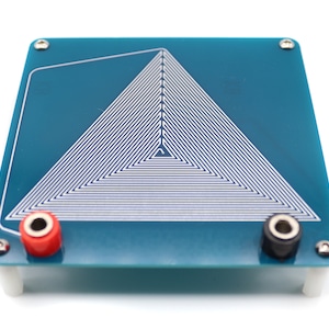 May include: A blue circuit board with a white triangular coil pattern. The board has two red and black wire terminals.