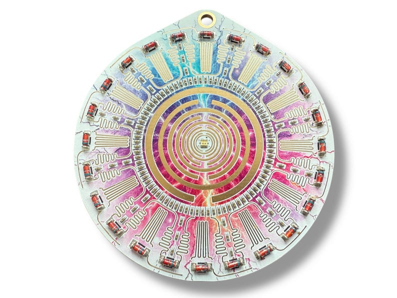 May include: A circular, white circuit board with a colorful, abstract design in the center. The design features a spiral pattern with gold accents and lightning bolts. The board is surrounded by a ring of red and white LED lights.