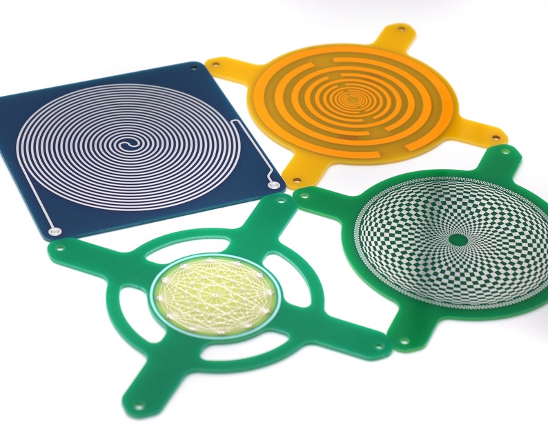 May include: Four different printed circuit boards with various patterns. The boards are green, blue, and orange. The patterns include a spiral, a checkerboard, and a geometric design.
