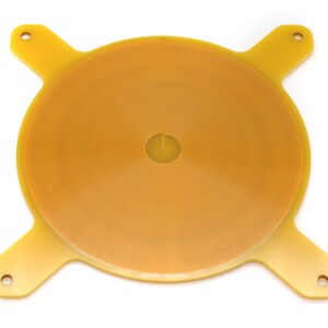 May include: A yellow circular electronic component with a spiral pattern and four arms extending from the edges.