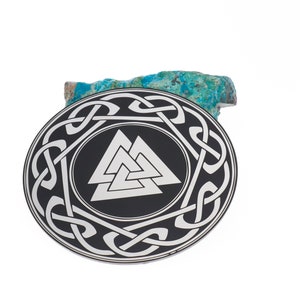 May include: A silver pendant with a black background and a silver Valknut symbol surrounded by a Celtic knot design.
