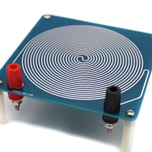 May include: A blue circuit board with a silver spiral coil in the centre. The board has two red and black banana plugs for connecting wires.