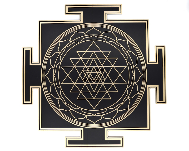May include: A black and gold Sri Yantra, a geometric design with interlocking triangles and a central lotus flower. The design is set against a black square with gold trim, creating a striking contrast. The artwork is a symbol of spiritual significance.