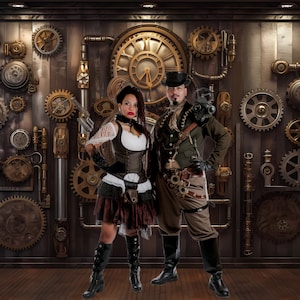 May include: Two people dressed in steampunk attire stand in front of a wall decorated with gears and cogs. The woman is wearing a brown corset, a black skirt, and a white shirt. The man is wearing a brown jacket, a black vest, and a black hat. Both are holding props.