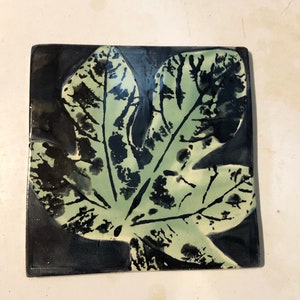 Black and green fig leaf print art trivet - handmade ceramic pottery with natural cork backing