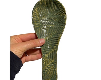 Handmade ceramic speckled kiwi green spoon rest with pressed vintage lace print texture