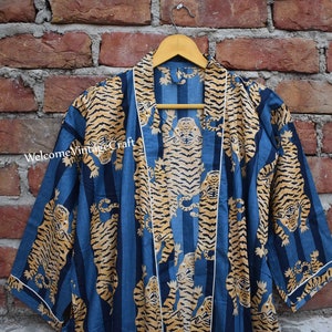 May include: A blue and gold cotton robe with a tiger print. The robe has a white trim and a tie closure.