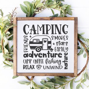 May include: A wooden sign with the text "Camping" in large letters. The sign also includes the words "friends", "adventure", "camp", "coffee", "fishing", "relax", "unwind", "s'mores", "stars", "family", and "nature". A small camper van is pictured in the center of the sign.