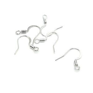 May include: A collection of silver-toned metal earring hooks, each featuring a curved wire design, a small coiled spring detail, and a circular loop at the base for attaching jewelry components. These findings are designed for crafting earrings.