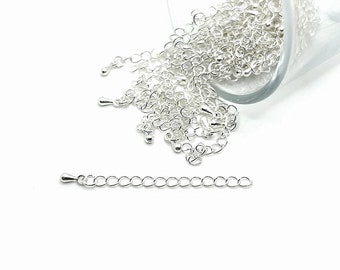 May include: A pile of silver chain links in a glass jar, with a separate short length of chain on a white background.