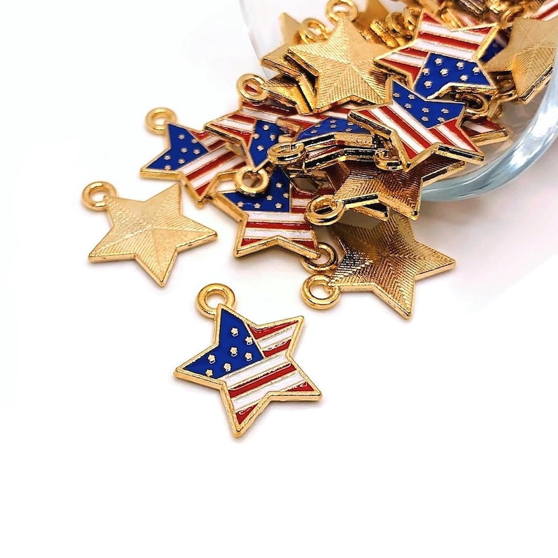 May include: A pile of gold-colored star-shaped charms with red, white, and blue enamel American flag designs.