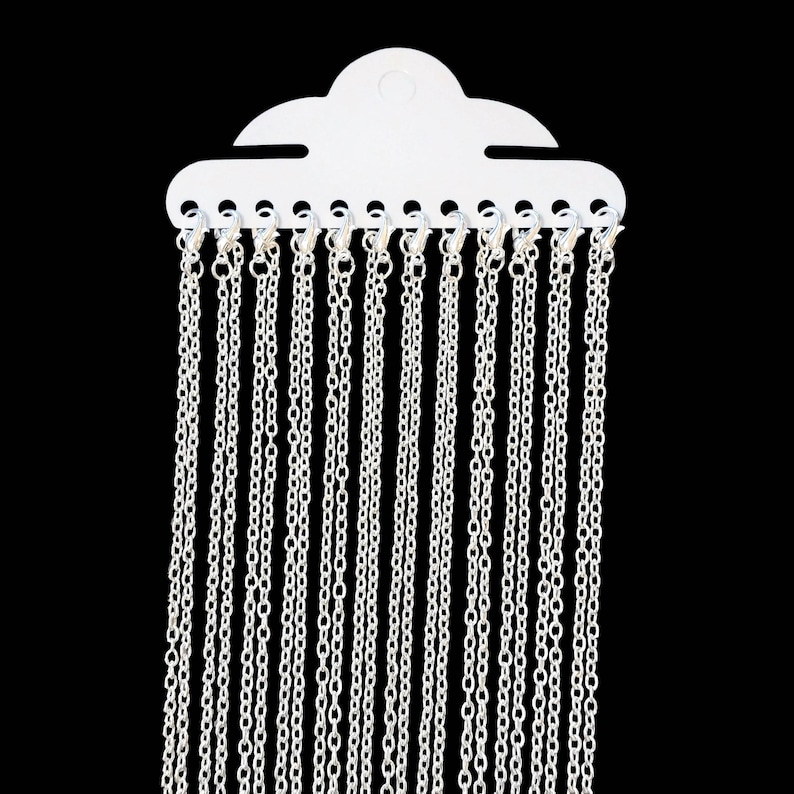 May include: A white plastic display card with 18 silver chains hanging from it.