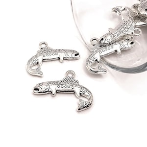May include: Silver-toned fish charms with a detailed design. The charms are perfect for jewelry making, scrapbooking, and other craft projects.
