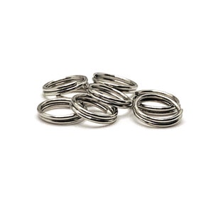 May include: A close-up of six silver key rings. The rings are made of metal and have a smooth finish.