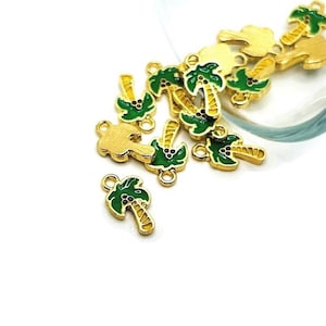 May include: A group of gold-colored palm tree charms with green leaves and brown trunks. The charms have a loop at the top for attaching to jewelry or other crafts.