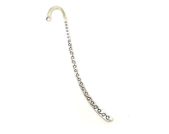 May include: Silver bookmark with a decorative design of black swirls along the length of the bookmark.